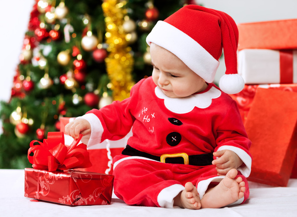 Cute little baby santa opening gift for christmas - Fotografie, Obrázek