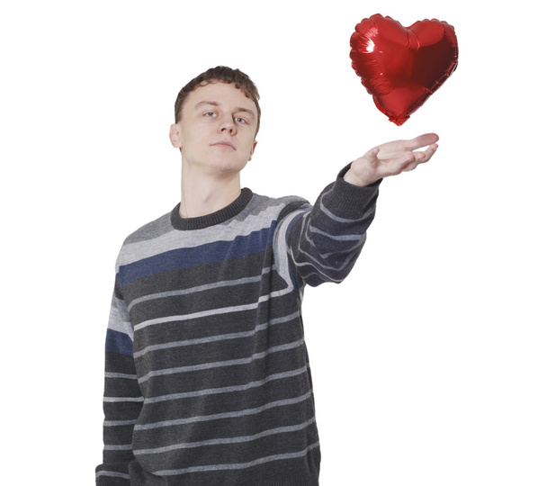 Young handsome man with red heart balloon - Foto, Bild