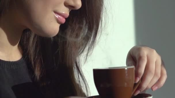 Beautiful young woman enjoying coffee. - Materiaali, video