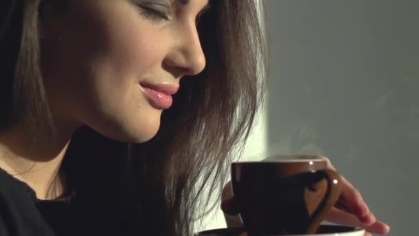 Lady with cup of steaming beverage. - Materiał filmowy, wideo