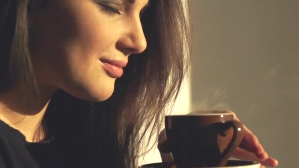 Beautiful young woman enjoying coffee. - Materiał filmowy, wideo