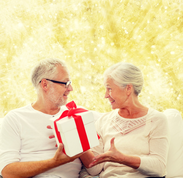 happy senior couple with gift box at home - Photo, image