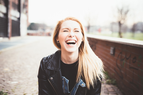 Blonde woman in the city laughing - Fotografie, Obrázek