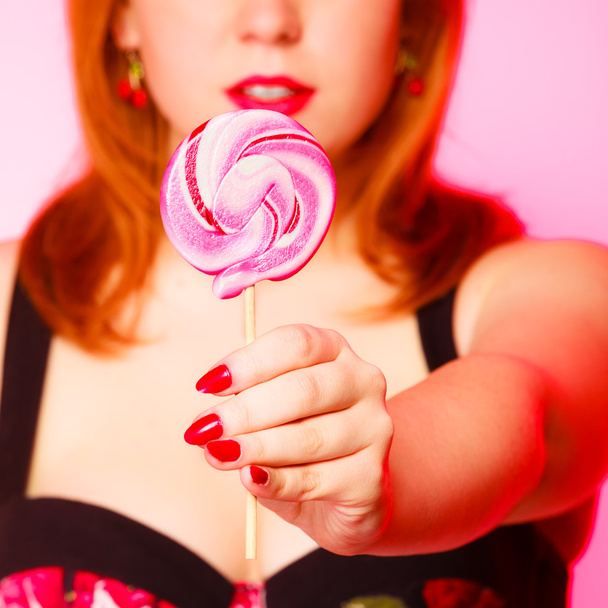 Woman with sweet candy lollipop in hand. - Фото, изображение