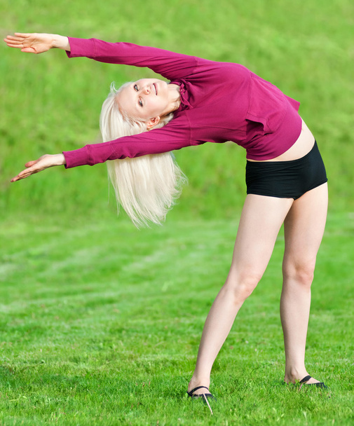Beautiful woman doing yoga stretching exercise - Fotó, kép