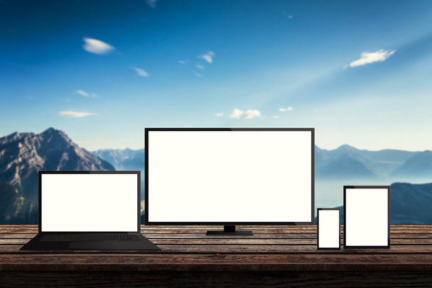 isolated responsive computer and mobile devices on desk with mountain nature background for mock up presentation - Photo, Image