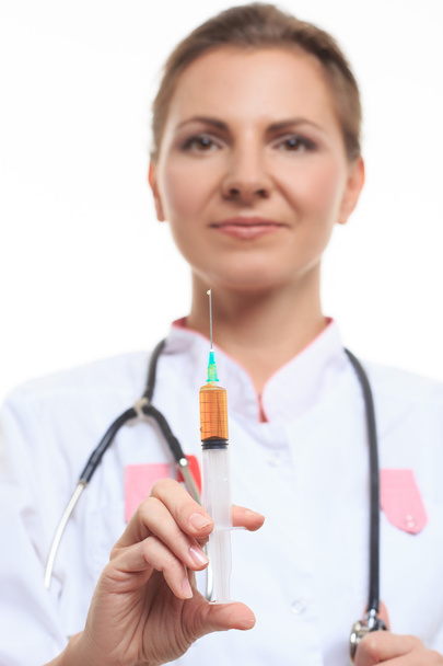 Young female doctor holding a syringe - 写真・画像