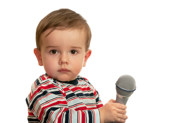 Thoughtful toddler with microphone - Foto, imagen