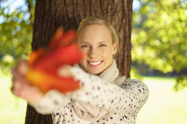 Attractive Young Woman Holding Autumn Leaf - Foto, imagen