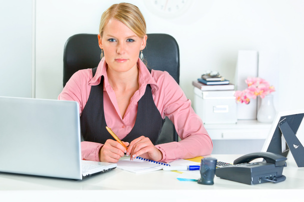Authoritative business woman sitting at office desk - Valokuva, kuva