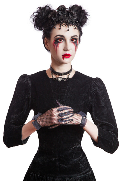 Young beautiful gothic woman with white skin and red lips. Halloween makeup. - 写真・画像