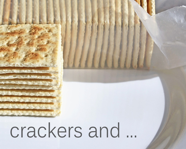 Stack of crispy soda crackers on plate to be enjoyed plain or with a topping - Photo, Image