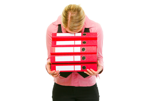 Tired female business clerk put her head on folders stack - Фото, изображение