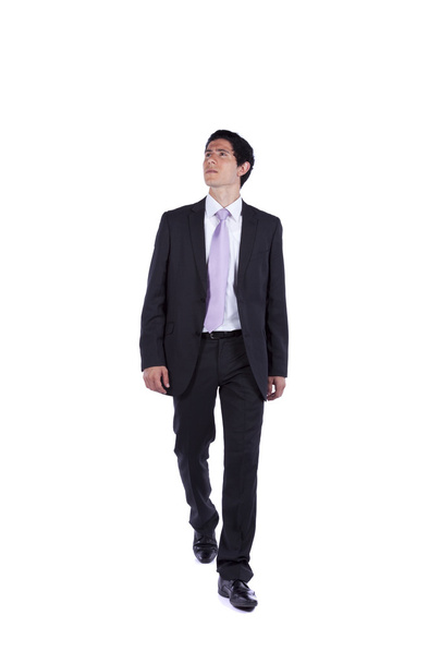 Businessman walking and looking up - Фото, зображення