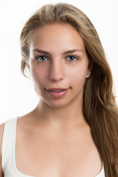 Portrait of a pretty blonde teen girl on a light background. - Фото, зображення