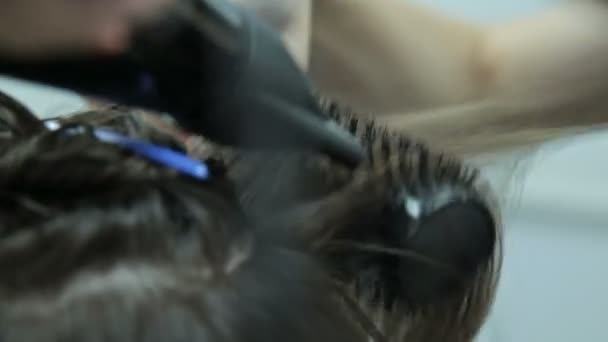 Hairstylist with brush and dryer. hairdresser drying hair of female client. Woman in hairdressing beauty salon. - Footage, Video