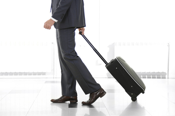 Man holding suitcase - Photo, Image