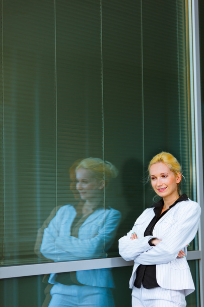 Pensive business woman standing near office building - Fotó, kép