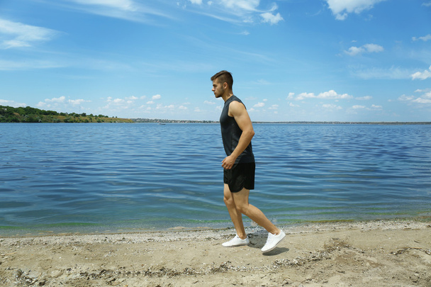man jogging on beach - 写真・画像