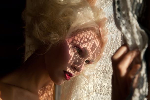 Beautiful blonde looking out through the window - Φωτογραφία, εικόνα