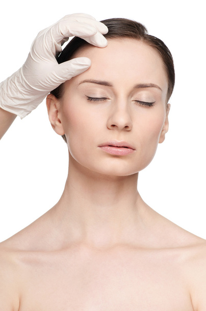 Beautician touch and exam health woman face. - Foto, immagini