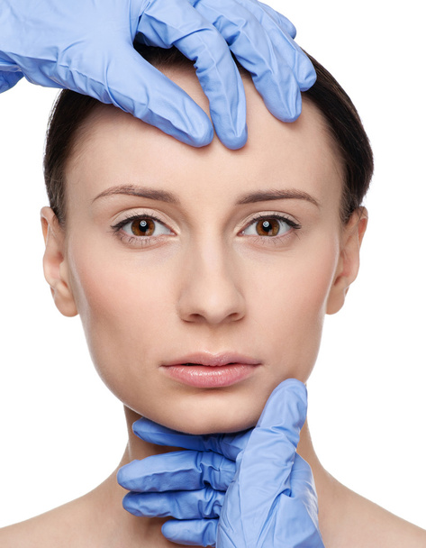 Beautician touch and exam health woman face. - Photo, Image