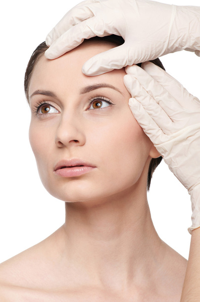 Beautician touch and exam health woman face. - Foto, imagen