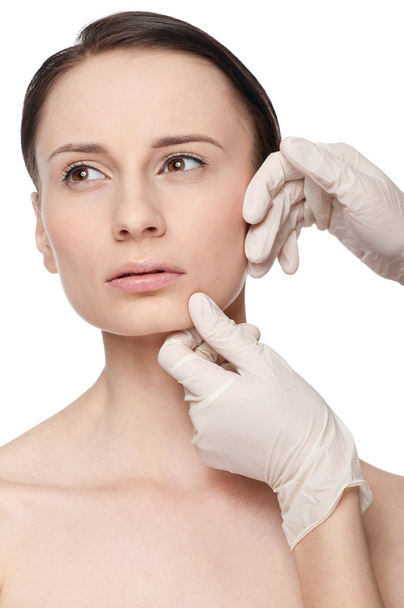 Beautician touch and exam health woman face. - Photo, Image