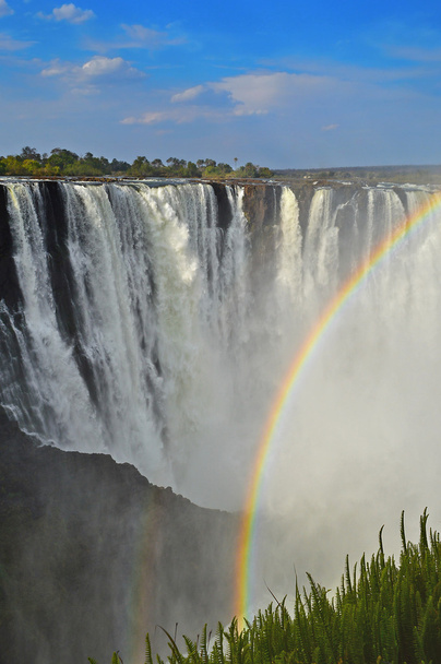 Victoria Falls and rainbow formed in the water spray. Zambezi River Zimbabwe Africa - Photo, Image