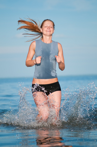 Sport woman running in water - Photo, Image