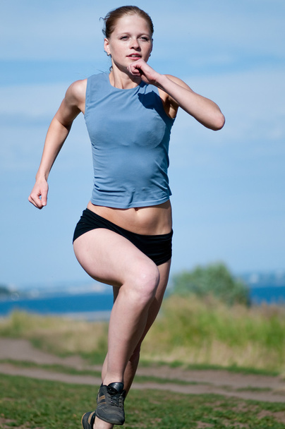 Young sport woman running on sunny day - Фото, зображення