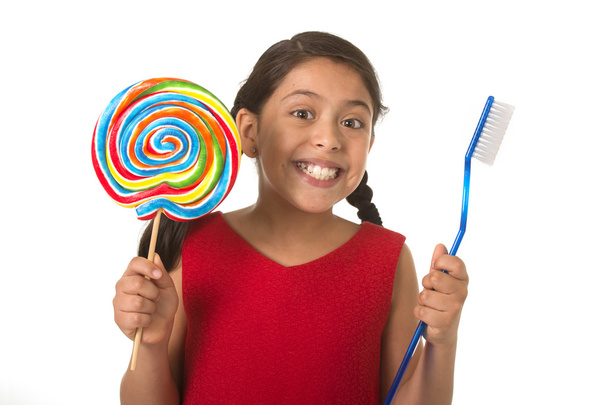 cute female child holding big spiral lollipop candy and huge too - Fotografie, Obrázek