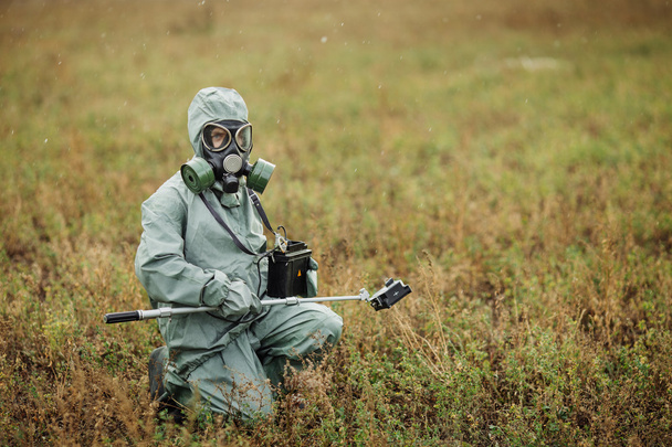 Scientist (radiation supervisor) in protective clothing and gas - 写真・画像