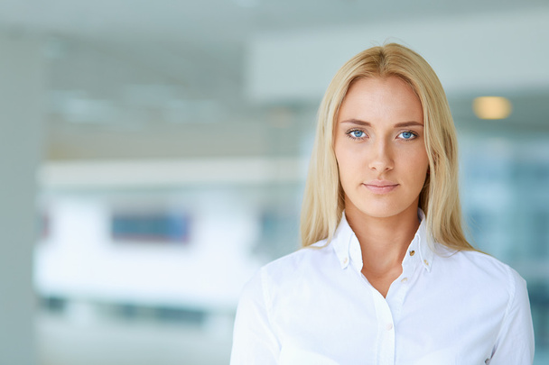 Young businesswoman standing in business center - Photo, image