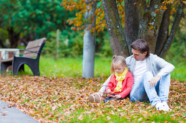 Young father with little daughter in autumn park outdoors - Photo, Image
