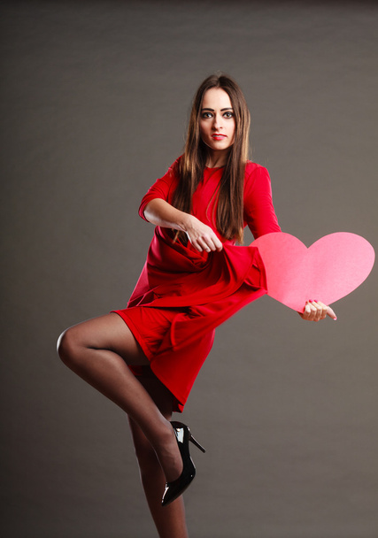 Woman in red dress holds heart sign - Foto, immagini