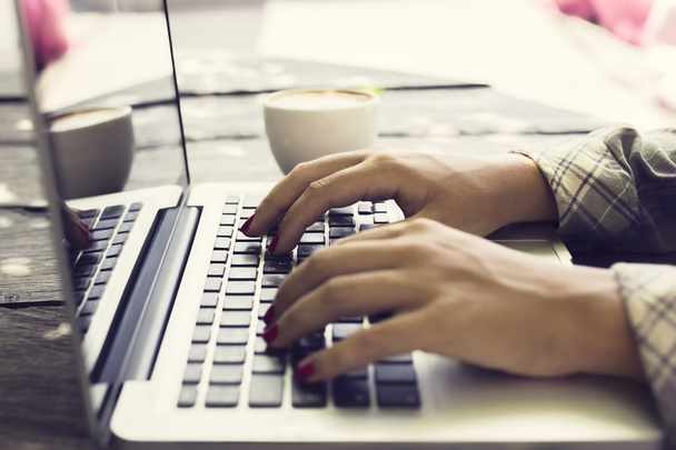 Typing girl with laptop and coffee - Zdjęcie, obraz