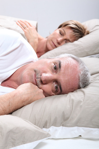 A man is awake when his wife is sleeping - Фото, изображение