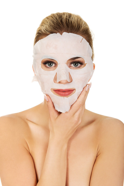 Young woman with facial mask - Foto, imagen