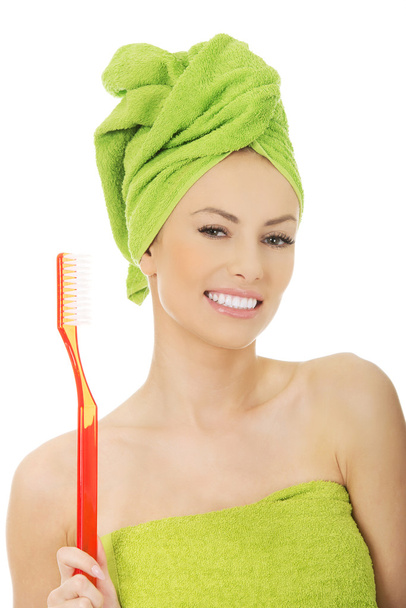 Beautiful woman with oversized toothbrush. - Zdjęcie, obraz