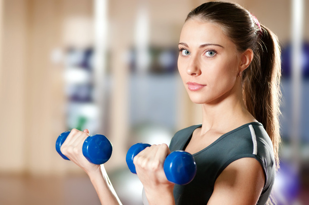 Beautiful sport woman doing exercise with dumbbell - Foto, Imagem