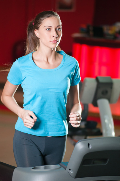Gym exercising. Run on on a machine. - 写真・画像