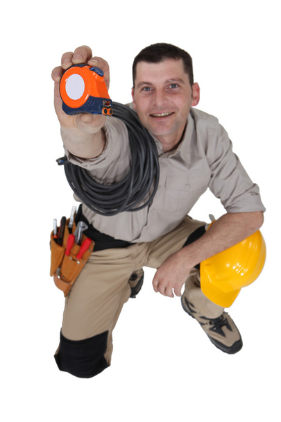Man holding up a measuring tape - Φωτογραφία, εικόνα