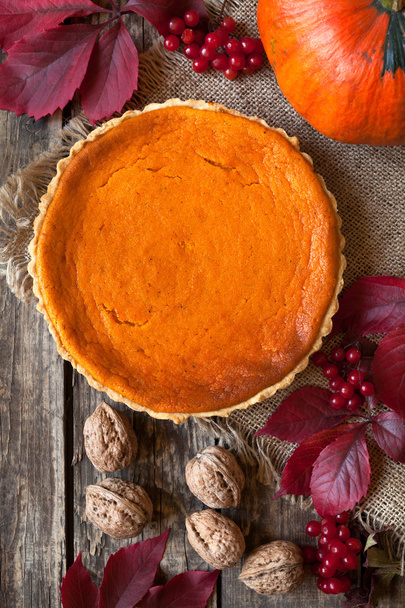 Homemade traditional pumpkin pie holiday celebration sweet dessert food. Haloween party delicious tart cake. Fall composition and vintage wooden background. - Photo, image