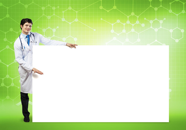 doctor with blank banner - Foto, afbeelding