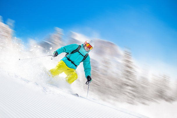 Skier skiing downhill in high mountains - Φωτογραφία, εικόνα