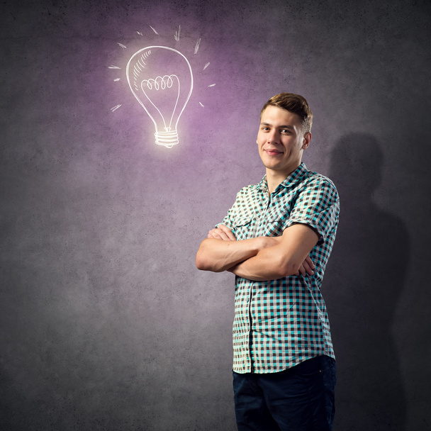 young man and light bulb - Photo, Image