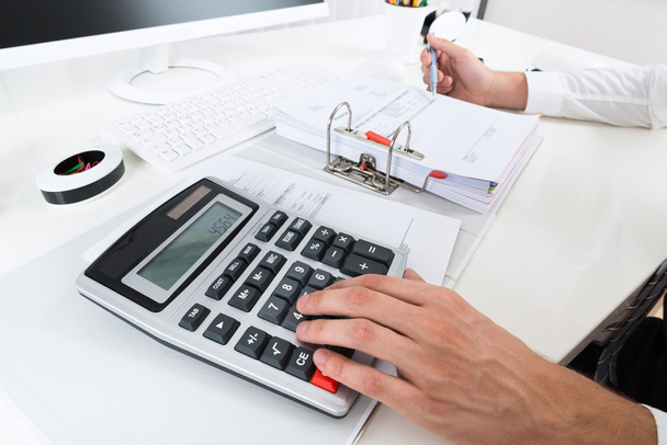 Businessperson Calculating Budget At Desk - Photo, Image
