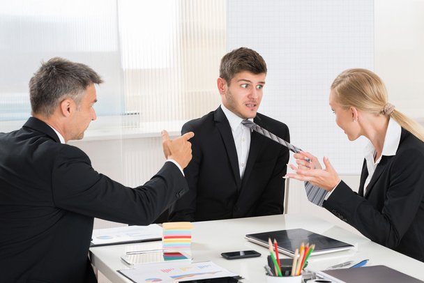 Two Businesspeople Quarreling To Young Businessman - Zdjęcie, obraz