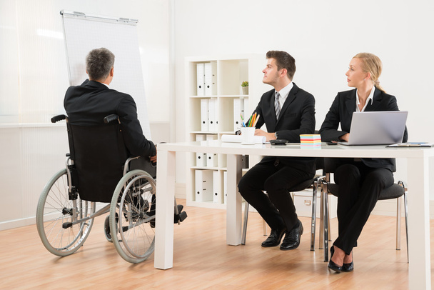 Handicapped Businessman Explaining To His Colleagues - Photo, image
